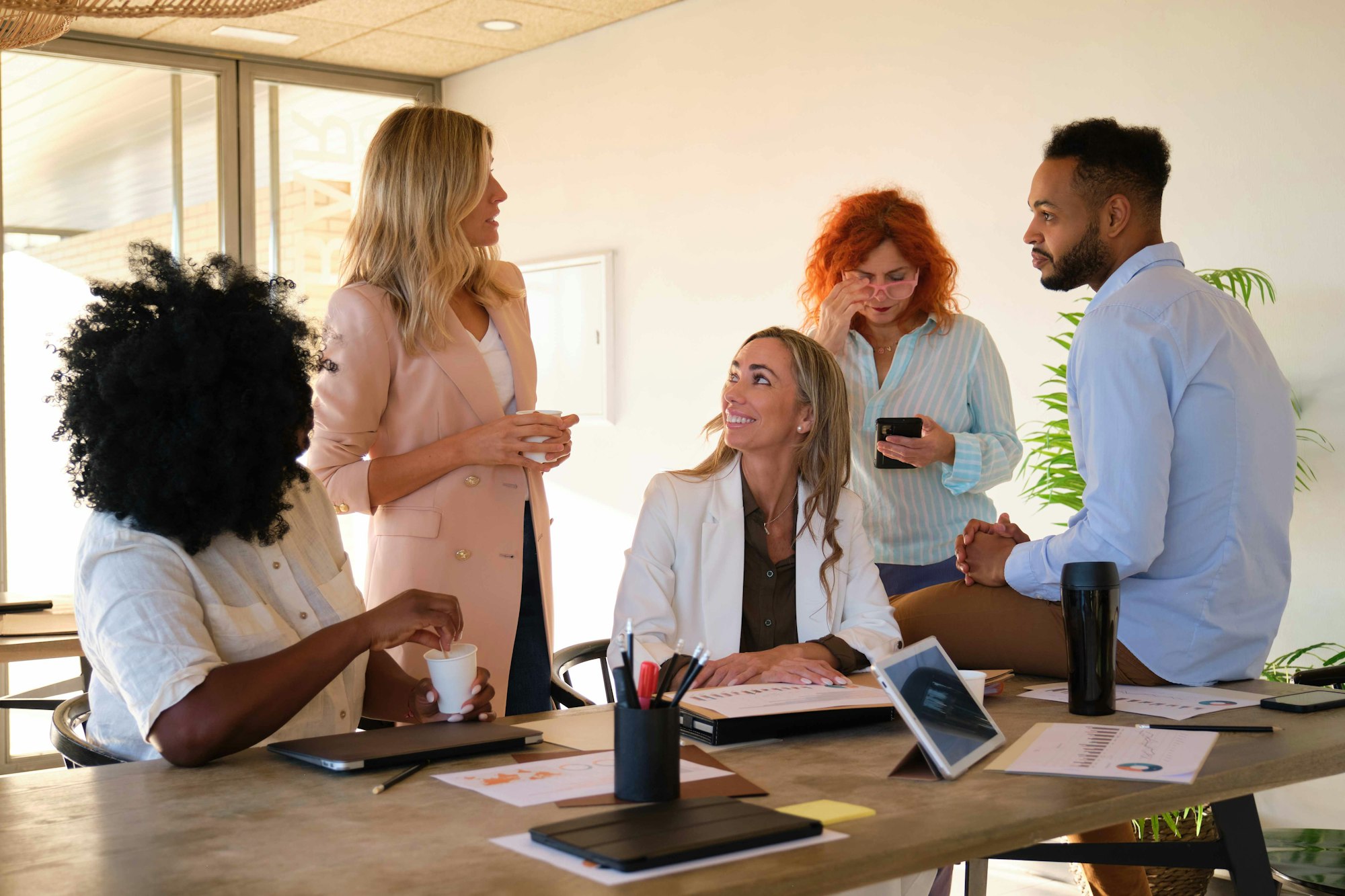 Business people doing team building during coffee break at a coworking.