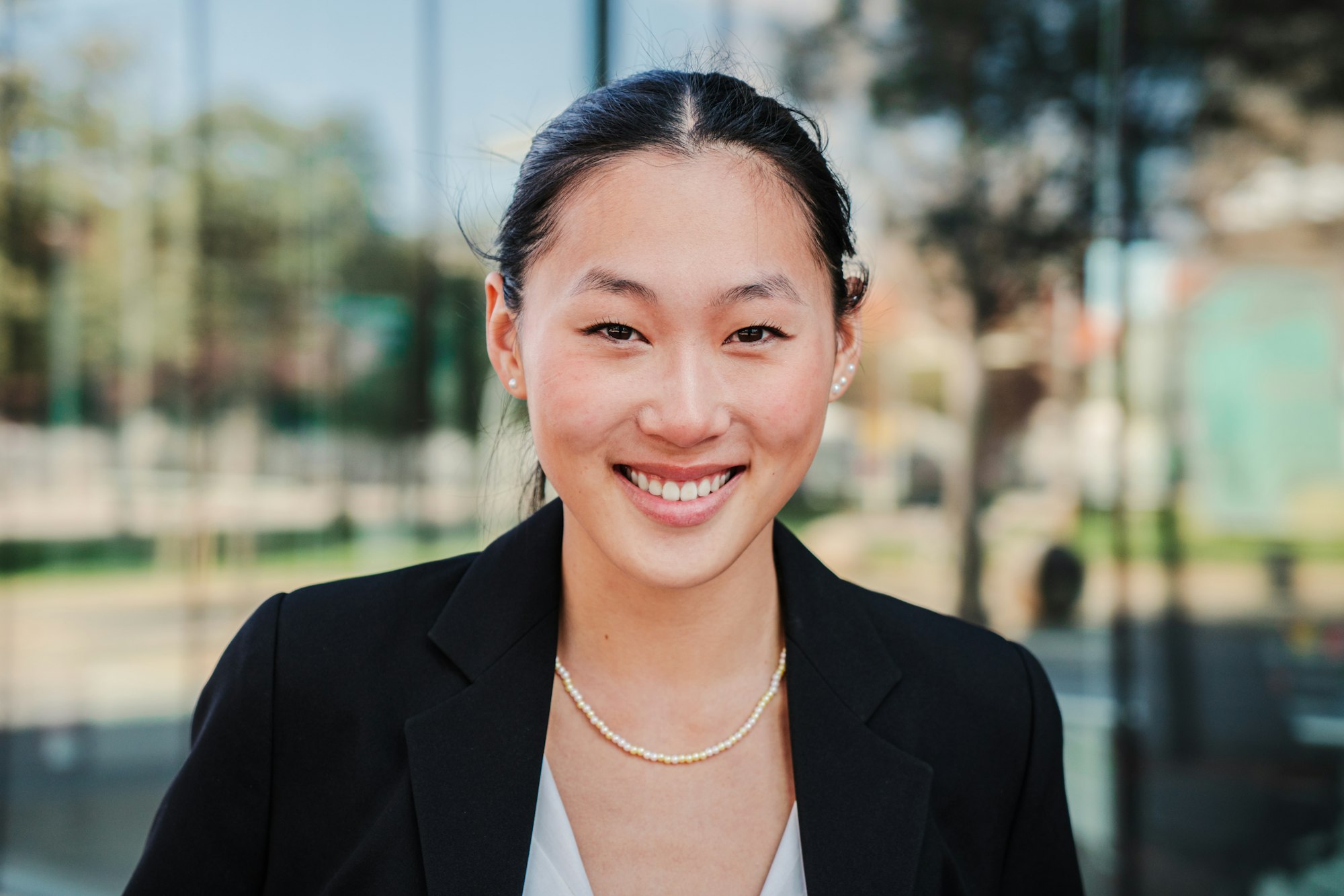 Individual close up portrait of one happy business woman looking at camera smiling with perfect