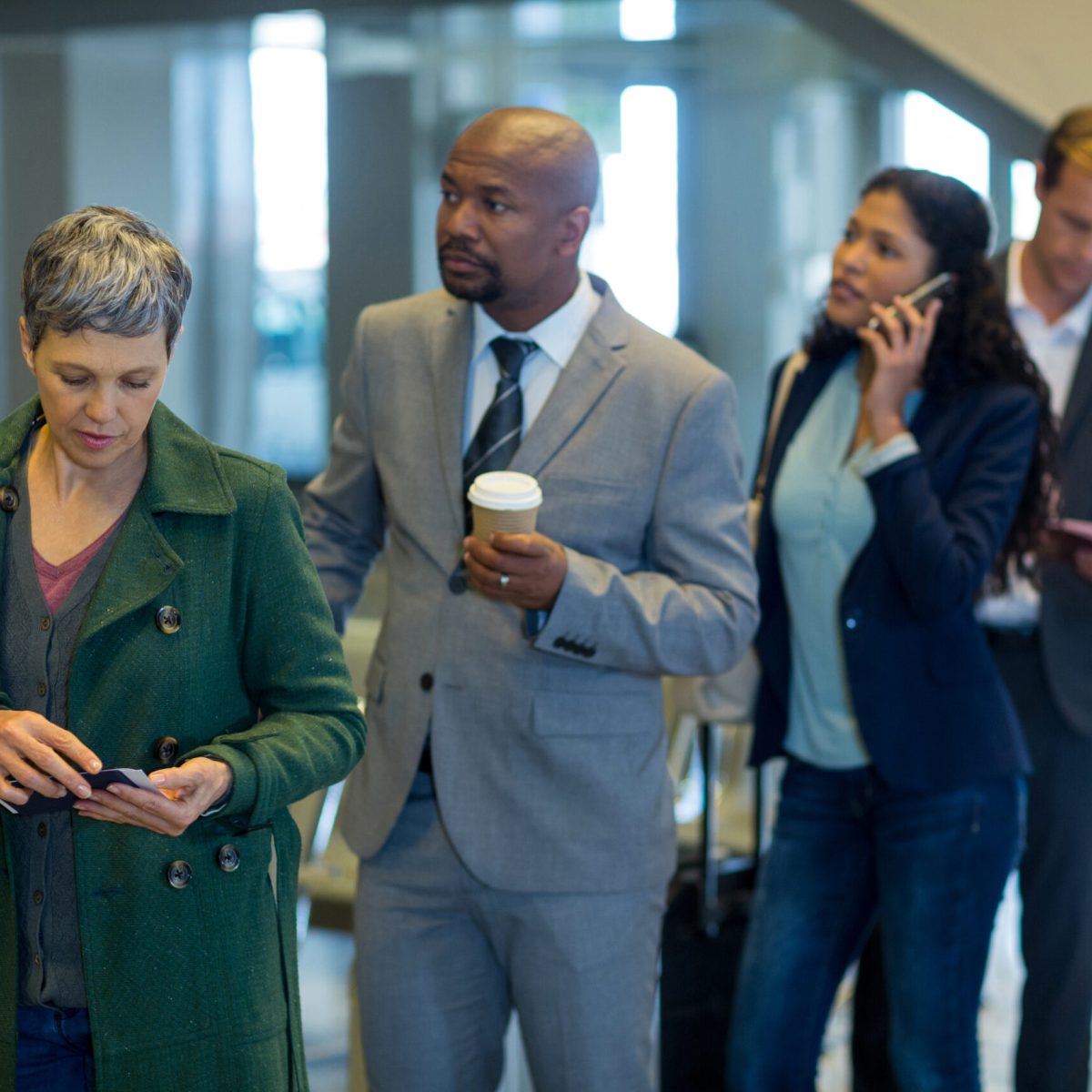 Business commuters waiting in queue at airport